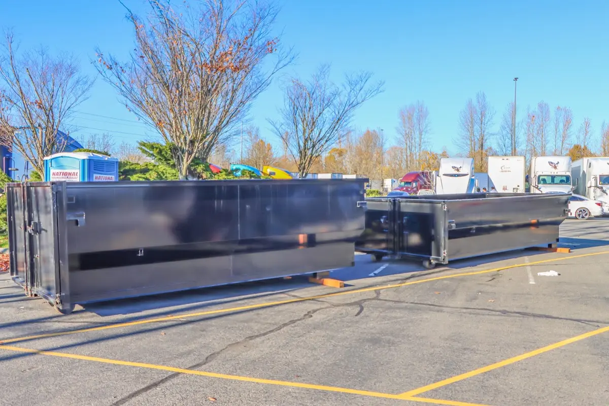 Professional dumpster rental service with roll-off container on residential driveway in Franconia